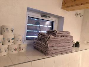 a pile of towels sitting on a counter next to a window at Domček pod Orechom in Blatnica +22 photos