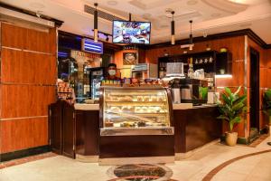 a bakery with a display case in a restaurant at Grand Plaza Al Madina in Al Madinah