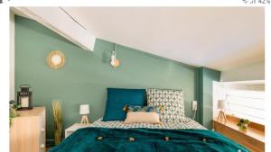 um quarto com uma cama com paredes azuis em Studio cosy, quai de Saône, centre ville em Lyon
