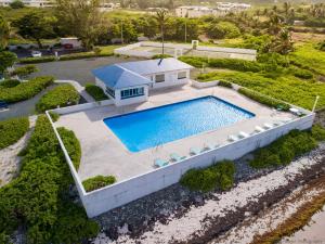 an aerial view of a house with a swimming pool at Gorgeous Ocean Views! Welcome to Bella Breeze! BeachFront 2BR 2BA in Sion Farm
