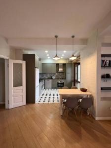a kitchen and dining room with a table and chairs at apartment Imperial business class on Frunze 300/3 in Bishkek