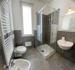 a bathroom with a shower and a toilet and a sink at Tea House Alghero in Alghero