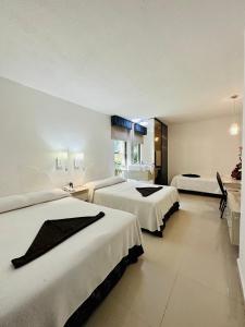 Postel nebo postele na pokoji v ubytování Hotel Plaza Caribe