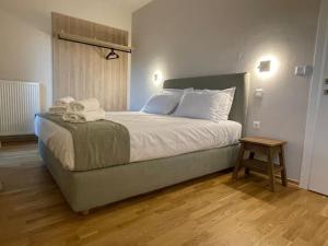 a bedroom with a large bed with towels on it at Agnanta Mountain Residence in Agnanta