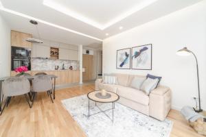 a living room with a couch and a table at Salus Hill Condo with private Garage in Budva +19 photos