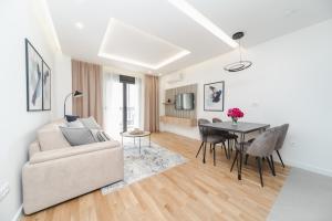 a living room with a couch and a table at Salus Hill Condo with private Garage in Budva