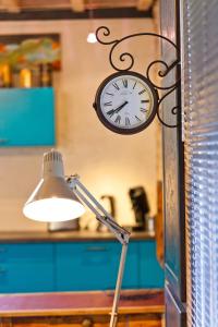 a clock hanging on a wall next to a lamp at Holiday Loft 58 in Arbois