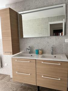 a bathroom with a sink and a mirror at La tour cachée in Mortain