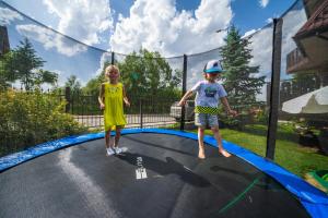 two children standing on top of a trampoline at Willa Rzepicha in Zakopane