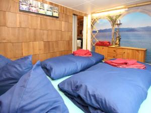 a room with two blue beds on a boat at Bungalow Wernsdorf in Wernsdorf