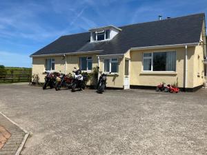 a group of motorcycles parked in front of a house at Yarningale in Moretonhampstead