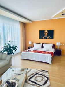 a large bedroom with a bed and a couch at Casa Constantin si Elena ( Adults only ) in Eforie Nord +56 photos