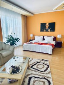 a large bedroom with a bed and a couch at Casa Constantin si Elena ( Adults only ) in Eforie Nord +56 photos
