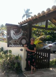 a woman standing in front of a sign at Sítio Maleleo in Porto De Galinhas