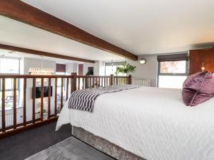 a bedroom with a large bed and a balcony at The Dairy in Carnforth