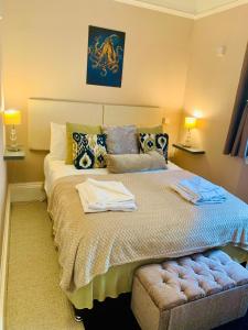 a bedroom with a large bed with towels on it at **Sunny and Bright, Thatchers Rock One bed beach front apartment*** in Torquay