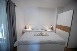 Posteľ alebo postele v izbe v ubytovaní Apartmani Jančić
