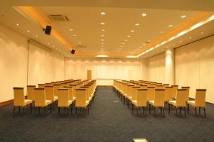 a large room with rows of tables and chairs at Aristoteles Holiday Hotel And Spa in Ouranoupoli +44 photos