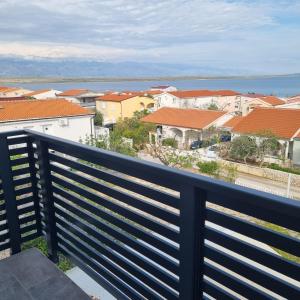 a balcony with a view of a city at Apartments Nada in Vir