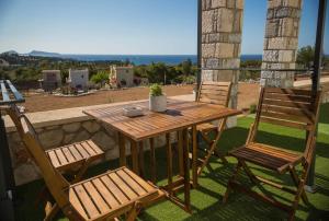 a wooden table and two chairs on a patio at Villa Amare in Porto Heli