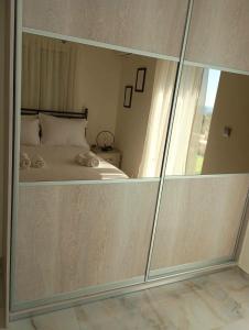 a bedroom with a bed with a large glass wall at Villa Amare in Porto Heli