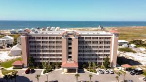 an aerial view of a hotel with the ocean in the background at The Dunes 502 by Vacation Homes Collection in Gulf Shores