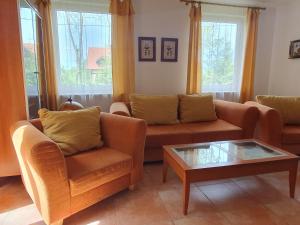 a living room with two couches and a coffee table at Dom Kapitana in Mikołajki
