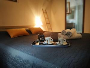 a tray with two cups of coffee on a bed at Casa Stella in Olmeto
