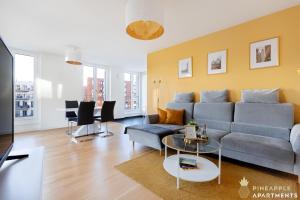 - un salon avec un canapé et une table dans l'établissement Pineapple Apartments Dresden Altstadt III - 91 qm - 1x free parking, à Dresde