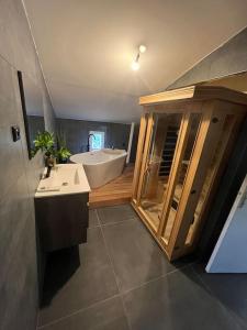een badkamer met een bad, een wastafel en een bad bij Bâtisse Provençale in Gréoux-les-Bains