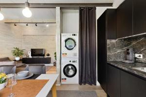 a kitchen and living room with a washer and dryer at Bungalow für 2 - Parkplatz - Küche - Terrasse in Speyer