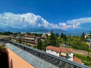 a view of a city from a balcony at La Mansarda in Stresa
