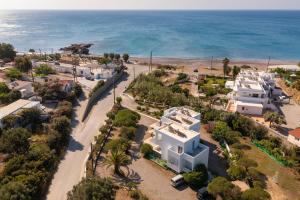 an aerial view of a beach with white houses at Tselios Apartments & Studios in Kiotari
