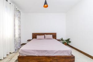 a bedroom with a bed with white sheets at Viccos Villa - Brand New Villa in Trou d'Eau Douce in Trou d'Eau Douce