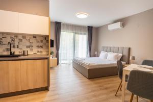 a small room with a bed and a kitchen at Open Sea Panorama Residence in Obzor +144 photos