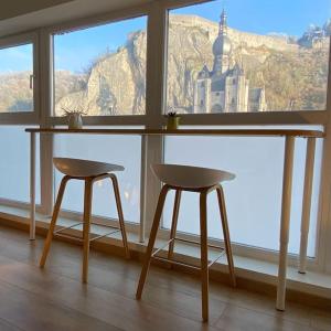 a table and two chairs in front of a window at L'Essentiel in Dinant