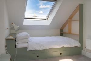 a bedroom with a bed with a window at Skerrow in New Galloway