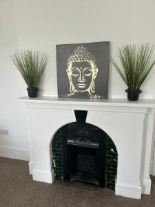 a fireplace with a statue on top of it at Merton rd serviced accommodation in Walton on the Hill