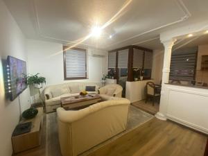 a living room with two white couches and a table at Hana in Konjic