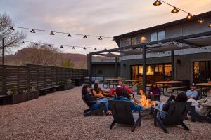 a group of people sitting around a fire pit at Field Station Moab in Moab