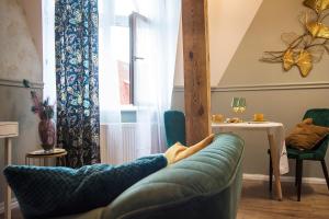 a living room with a couch in front of a window at Apartamenty Paderewskiego 1 in Bydgoszcz +42 photos