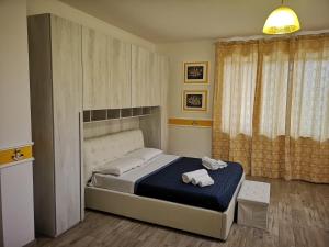 a bedroom with a bed with two towels on it at La Casa di Alfonso in Marina di Camerota