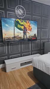 a room with a large screen tv on a wall at The Saxon Rooms in Barking +30 photos