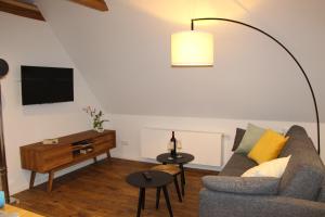 a living room with a couch and a flat screen tv at Ferienwohnung Fritz in Jork