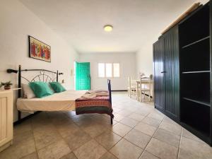 a bedroom with a bed and a blue door at COZY STUDIO CLOSE TO THE BEACH! in Santa Maria
