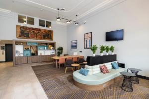 a living room with a couch and a table at Holiday Inn Victoria - Elk Lake by IHG in Victoria