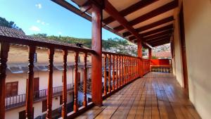 a balcony of a house with a view of the ocean at Korilazos in Cusco