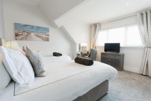 a bedroom with two beds and a television at Birkby Lodge Escape in Lytham St Annes