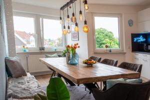 a dining room with a wooden table and chairs at City-House-Achern in Achern