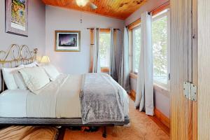 a bedroom with a large bed and a window at Hazen's Hideaway in North Hero